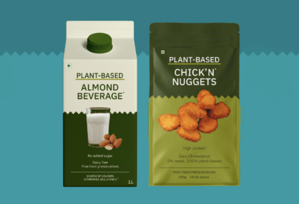 A carton of plant-based almond beverage and a packet of plan-based chicken nuggets.